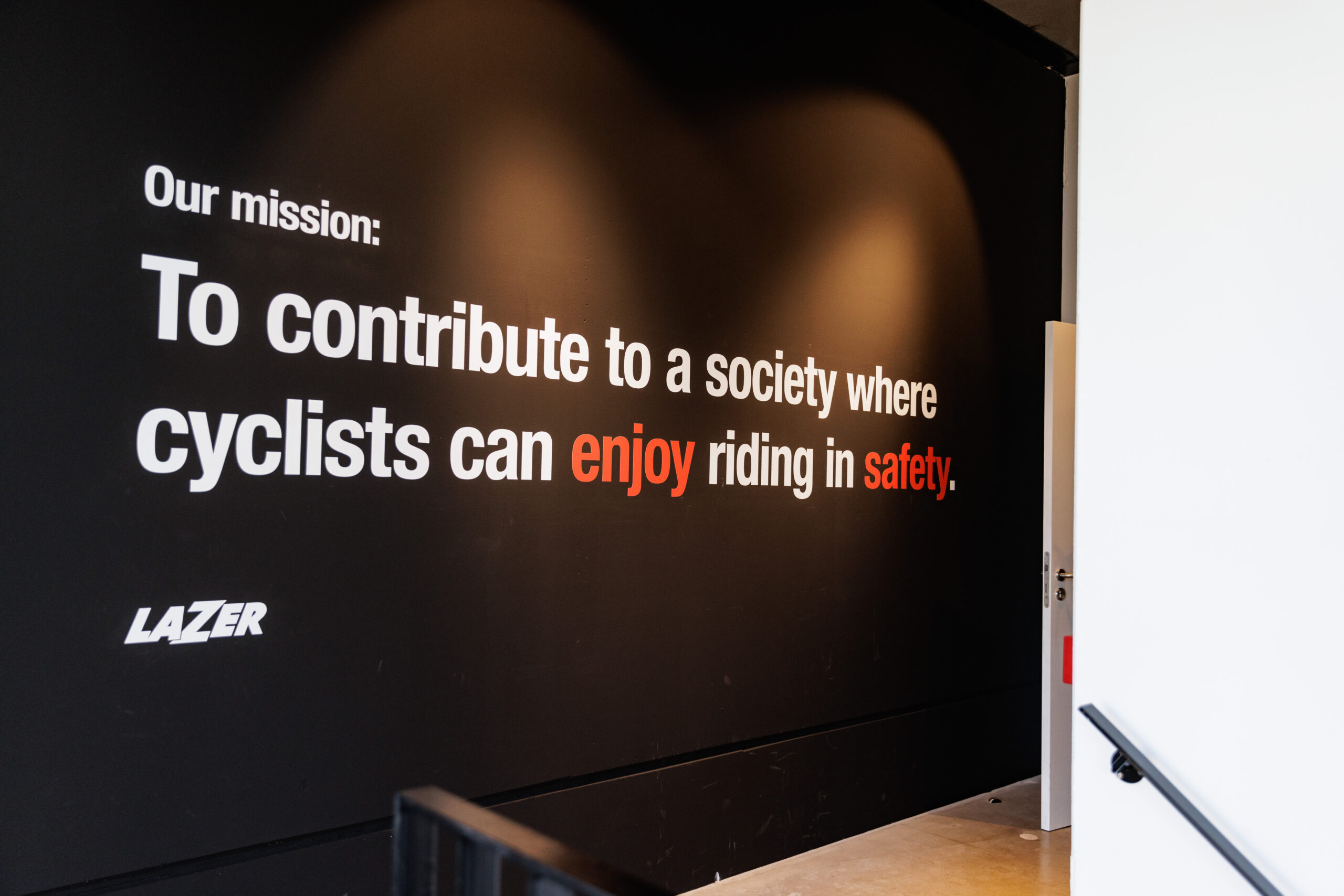 Lazer Brand Development mission statement emphasizing safety and enjoyment for cyclists in a modern workspace. - Alexi Hall